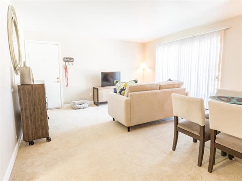 a living room and dining room with a couch and a table