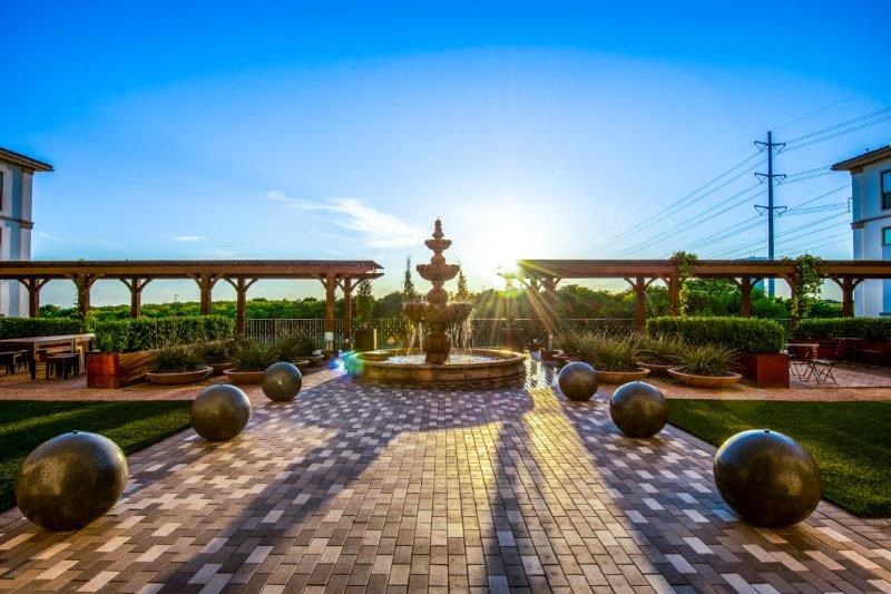 a fountain in the middle of a brick courtyard