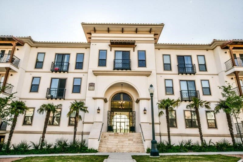 a white building with palm trees in front of it