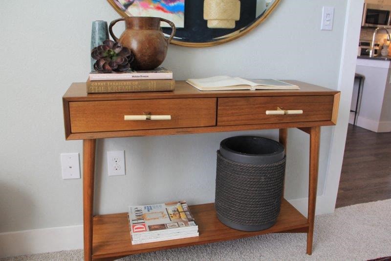 a table with a pot and books on it
