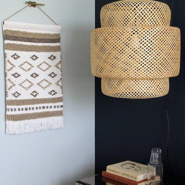 a bathroom with a basket hanging on the wall
