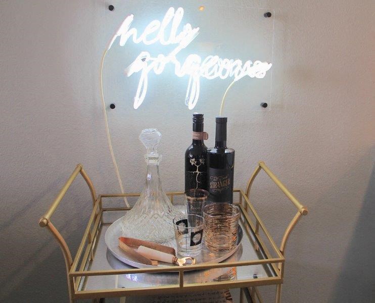 a table with a plate of food and bottles on it