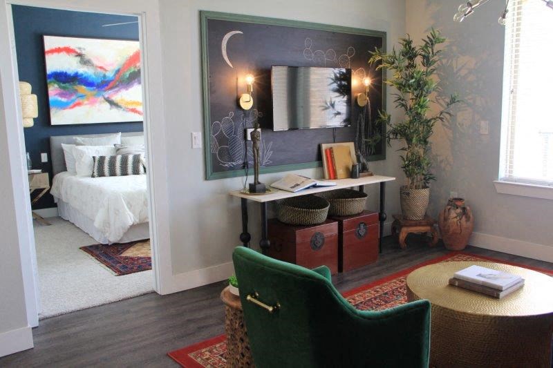 a bedroom with a bed and a desk with a mirror