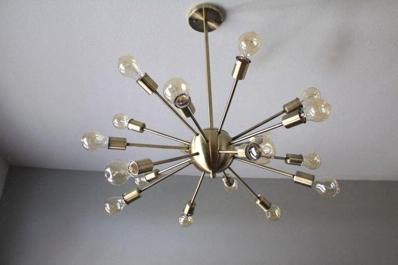 a chandelier hanging from a ceiling with many lights