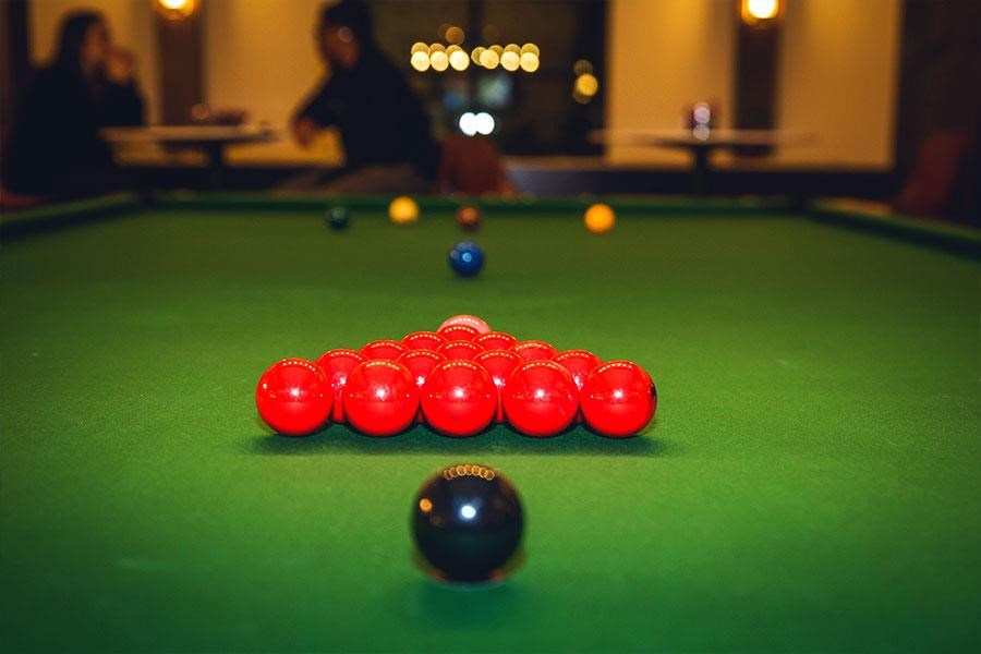 a set of red balls on a pool table