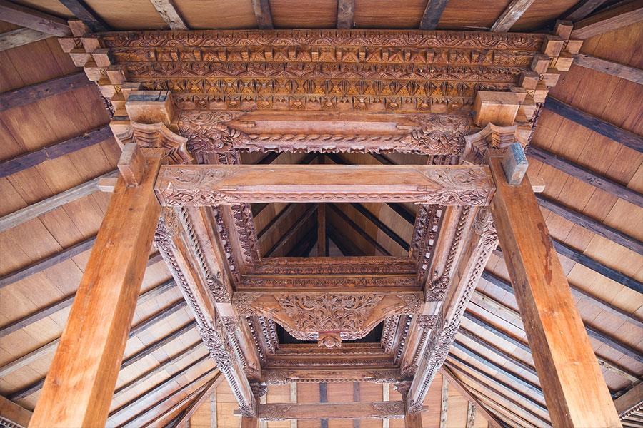 a view of the ceiling of a building with wooden beams