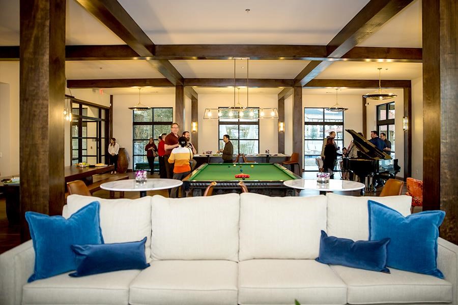 a game room with a pool table and a white couch