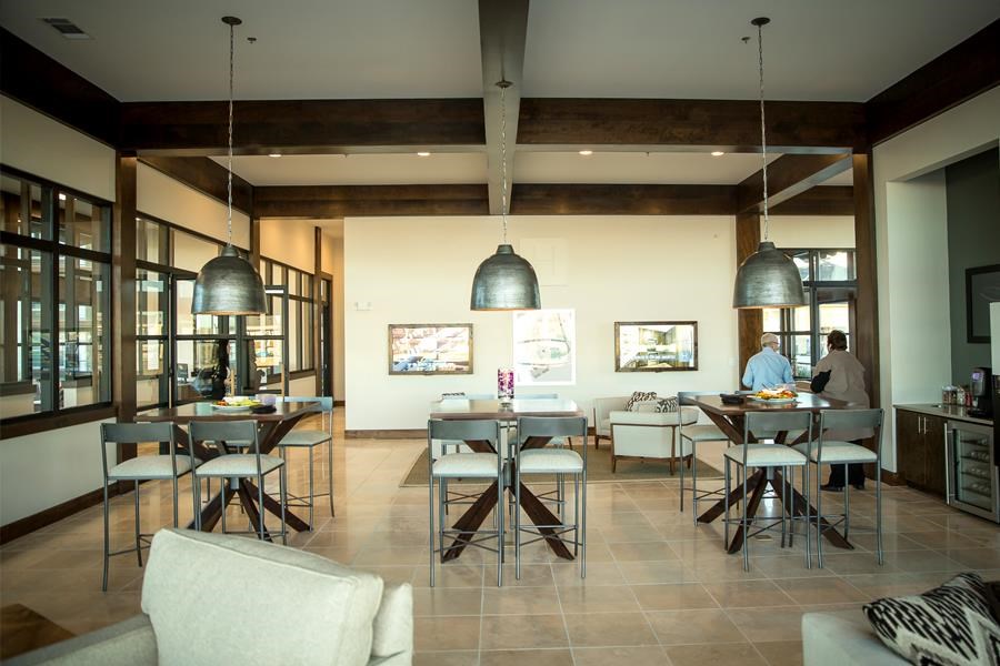 a large living room with tables and chairs