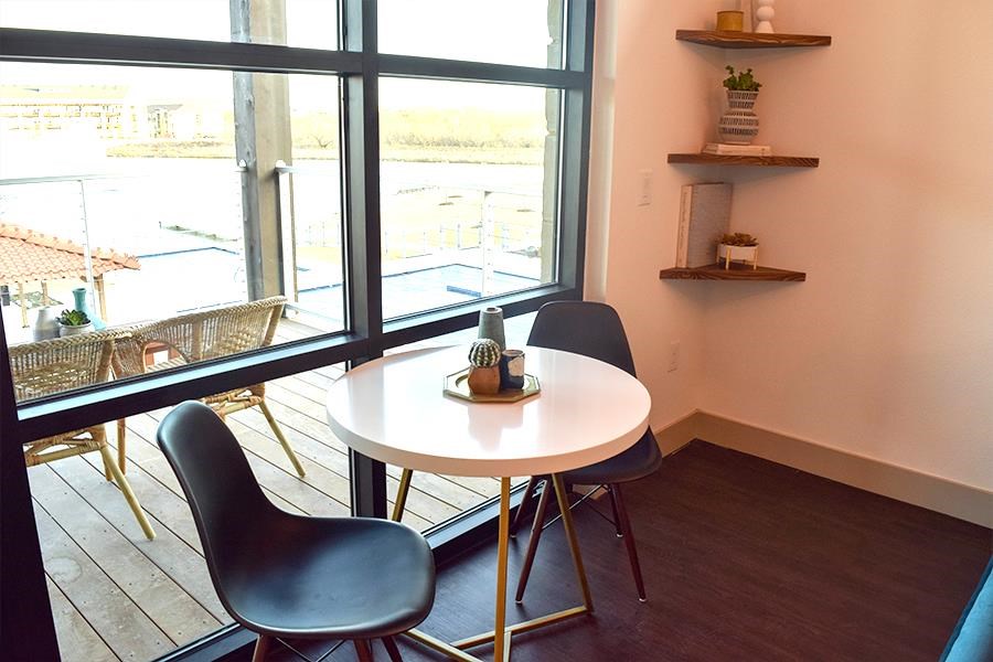 a dining room with a table and chairs and a window