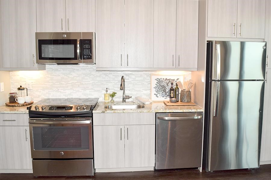 a kitchen with stainless steel appliances and white cabinets