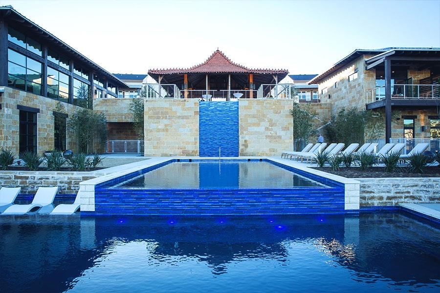 a large swimming pool in front of a building
