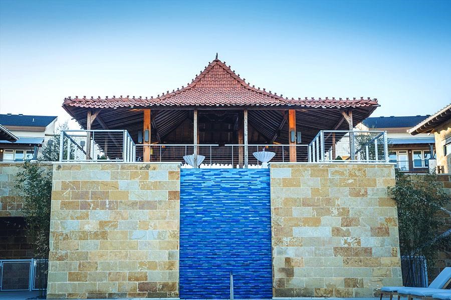 a building with a blue water fountain in front of it