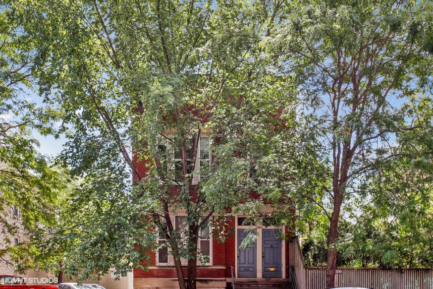 a red house with trees in front of it