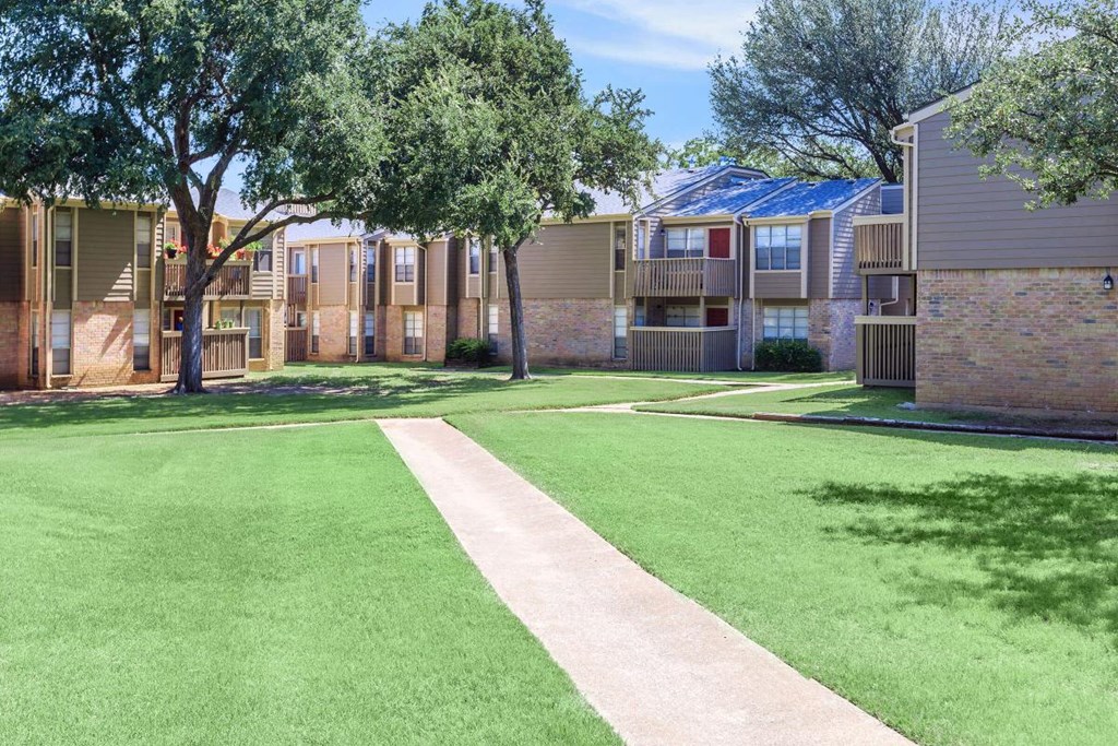 our apartments have a spacious courtyard with green grass and trees