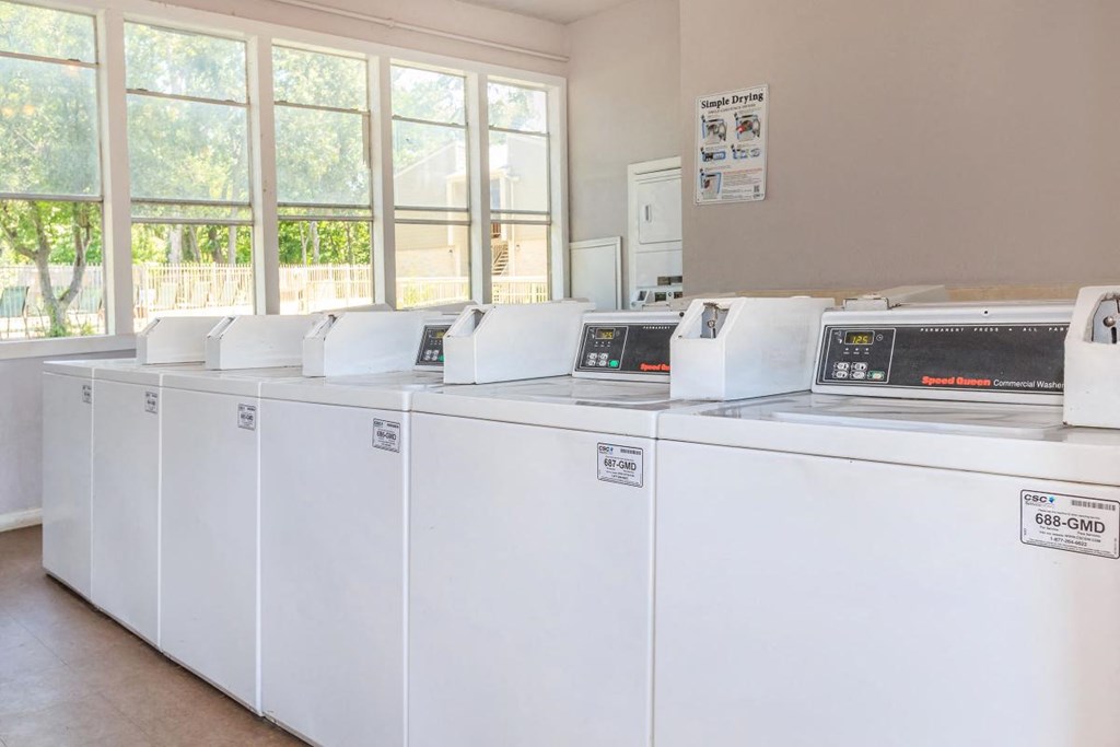 a group of white washing machines in a room