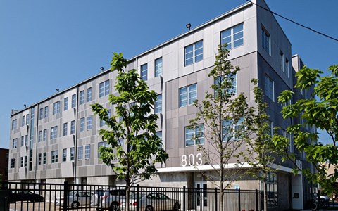 a large building with cars parked in front of it