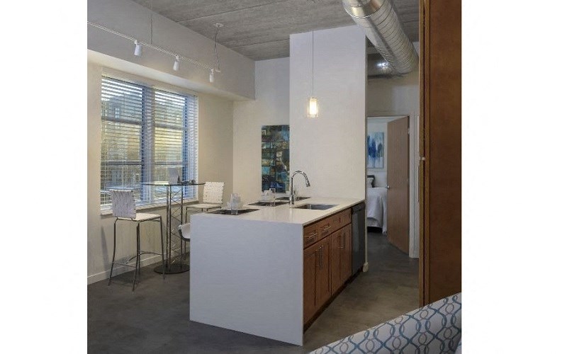 a view of a kitchen and a dining area in an apartment