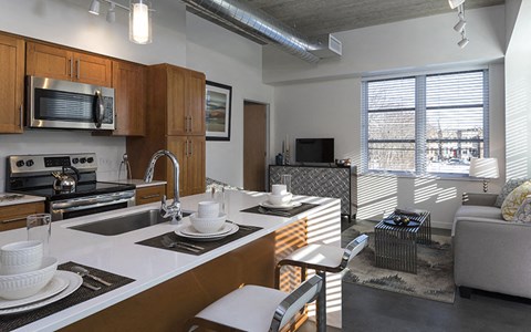 a kitchen and living room in an apartment