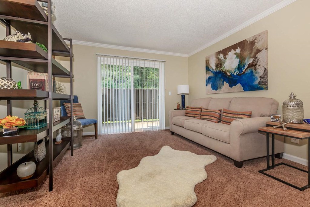 a living room with a couch and a sliding glass door