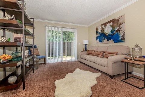 a living room with a couch and a sliding glass door