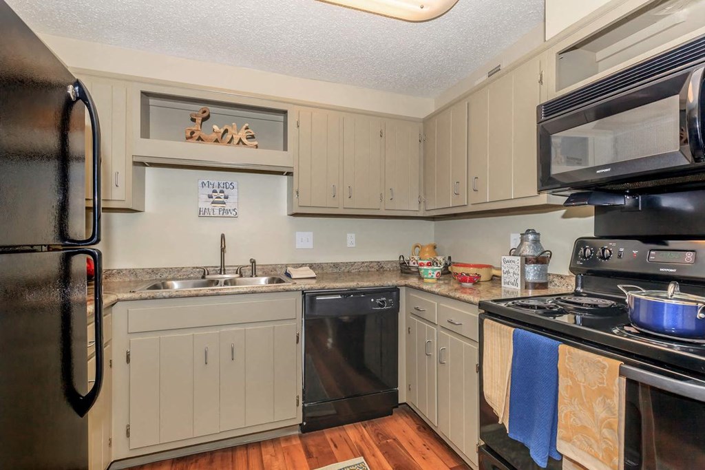 a kitchen with stainless steel appliances and white cabinets