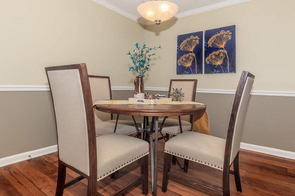 a dining room with a wooden table and chairs