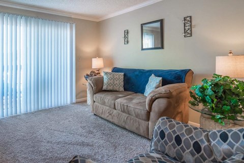 a living room with a couch and a window