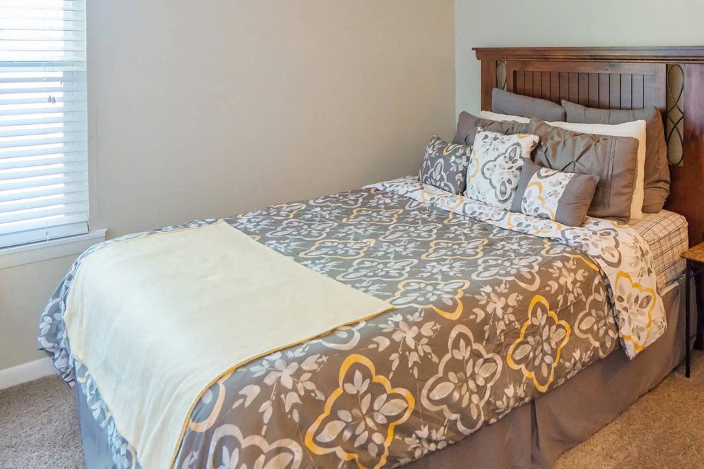 a bedroom with a bed and a window