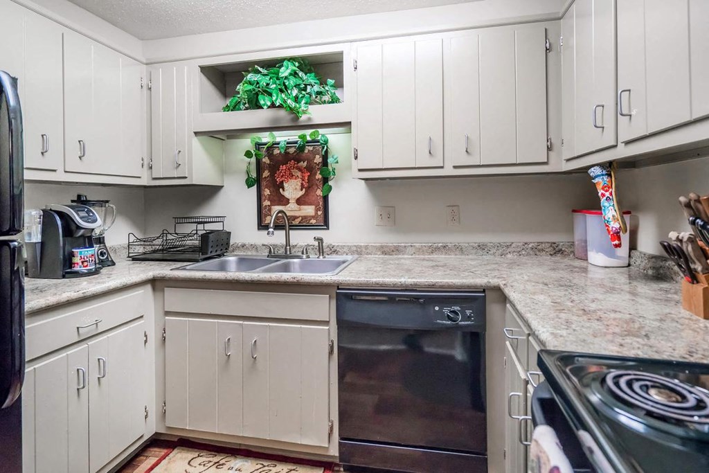a kitchen with white cabinets and a sink