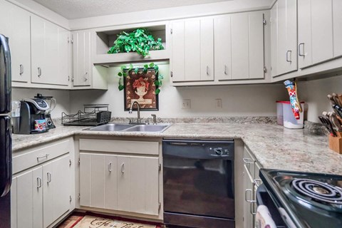 a kitchen with white cabinets and a sink