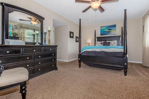 a bedroom with a bed and a large mirror