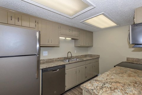 a kitchen with stainless steel appliances and granite counter tops