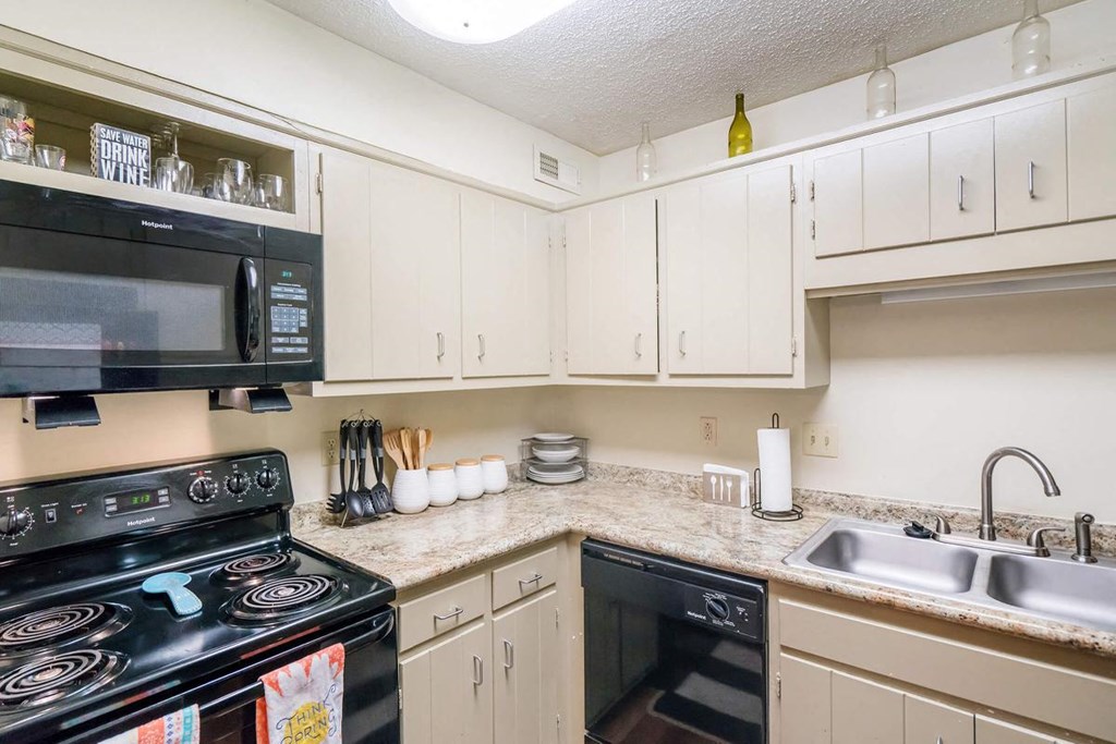 a kitchen with a stove microwave and sink