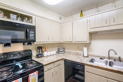 a kitchen with a stove microwave and sink