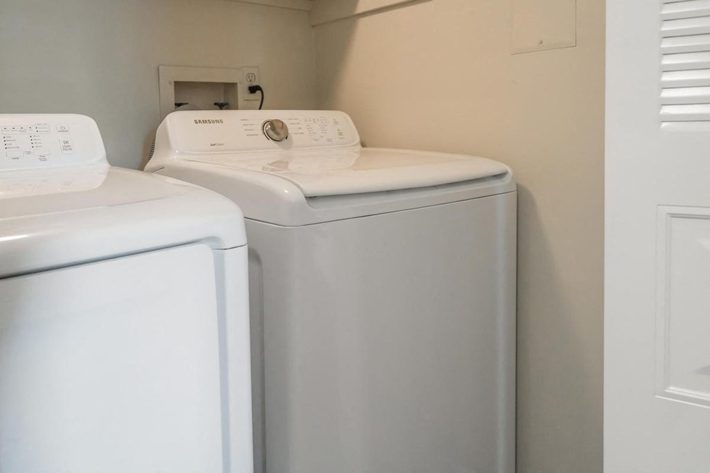 a white washer and dryer in a laundry room