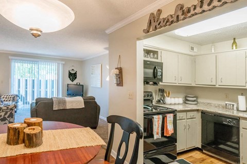 a kitchen and dining room with a table and a living room