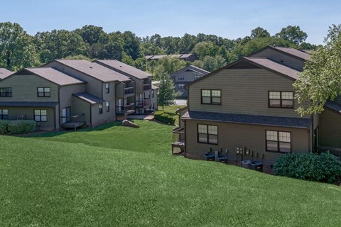 an aerial view of houses on a grassy hill