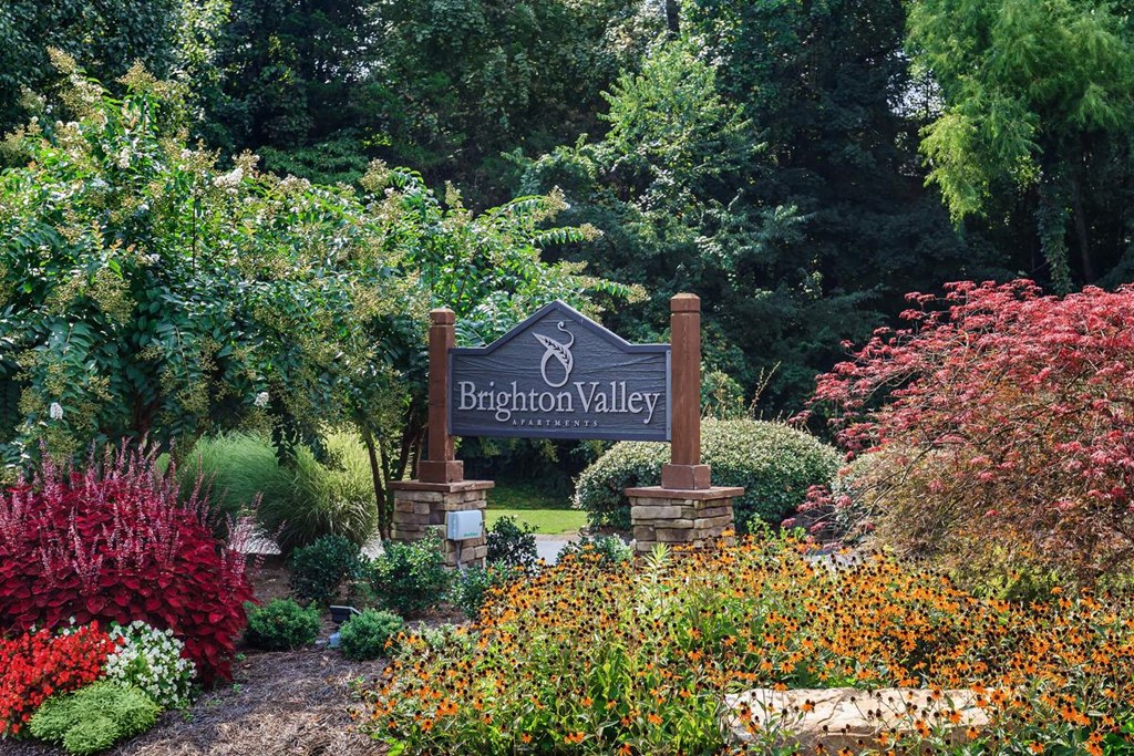 a sign for brighton valley in a garden