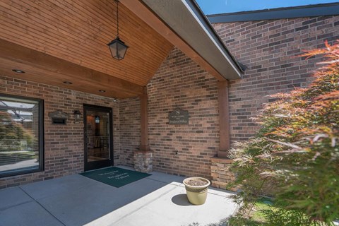 the front porch of a brick house with a ramp to the door