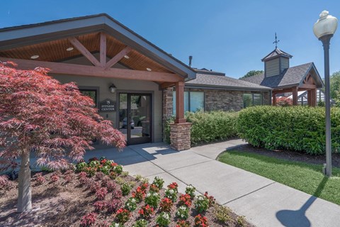 a sidewalk in front of a building with a glass door