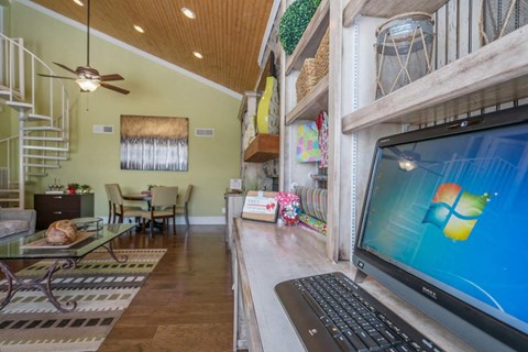 a computer sitting on a desk in a living room