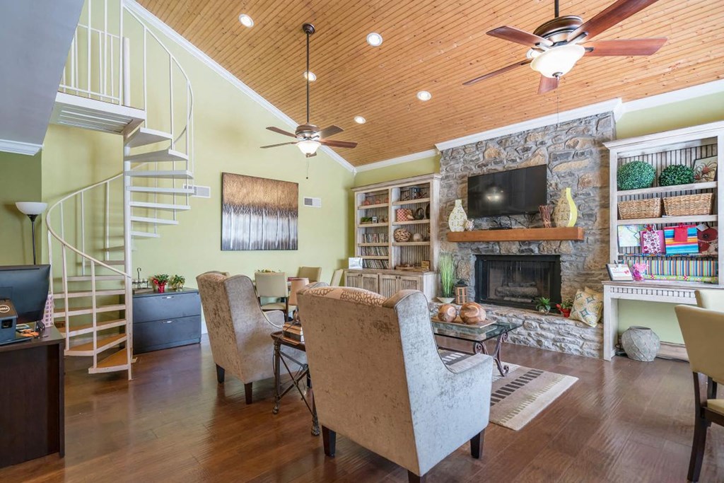 a living room with a fireplace and a spiral staircase