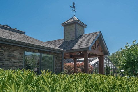 a small building with a weather vane on top of it