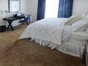 a bedroom with a bed and a desk