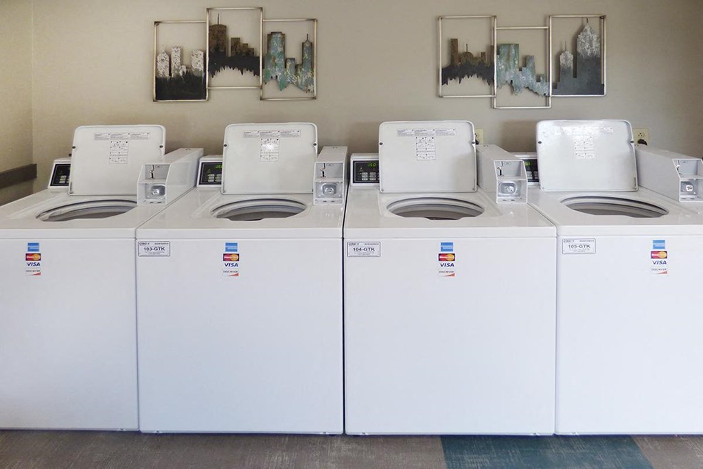 a row of white washing machines and toilets
