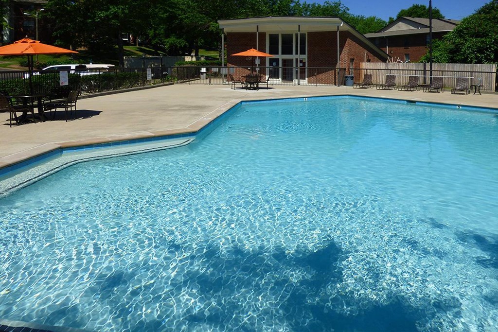 a large swimming pool in front of a house