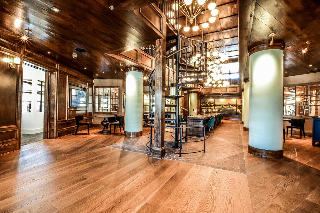 the lobby of a restaurant with a spiral staircase