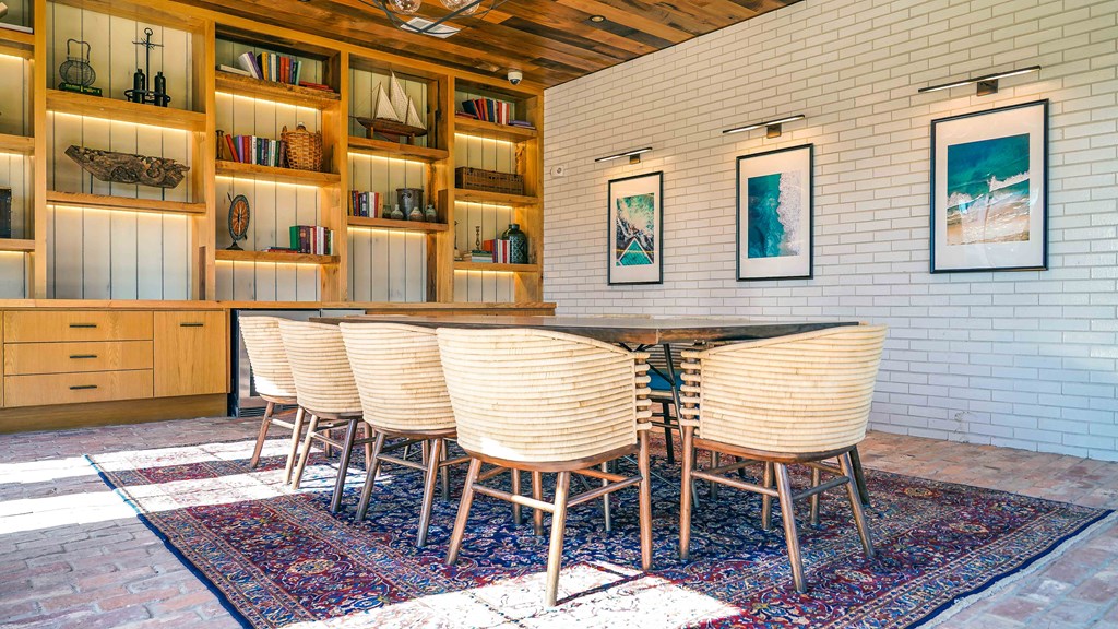 a dining room with a wooden table and chairs