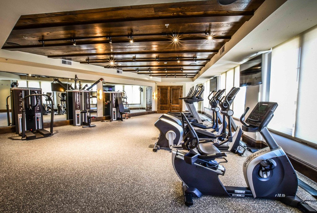 a gym with treadmills and other exercise equipment