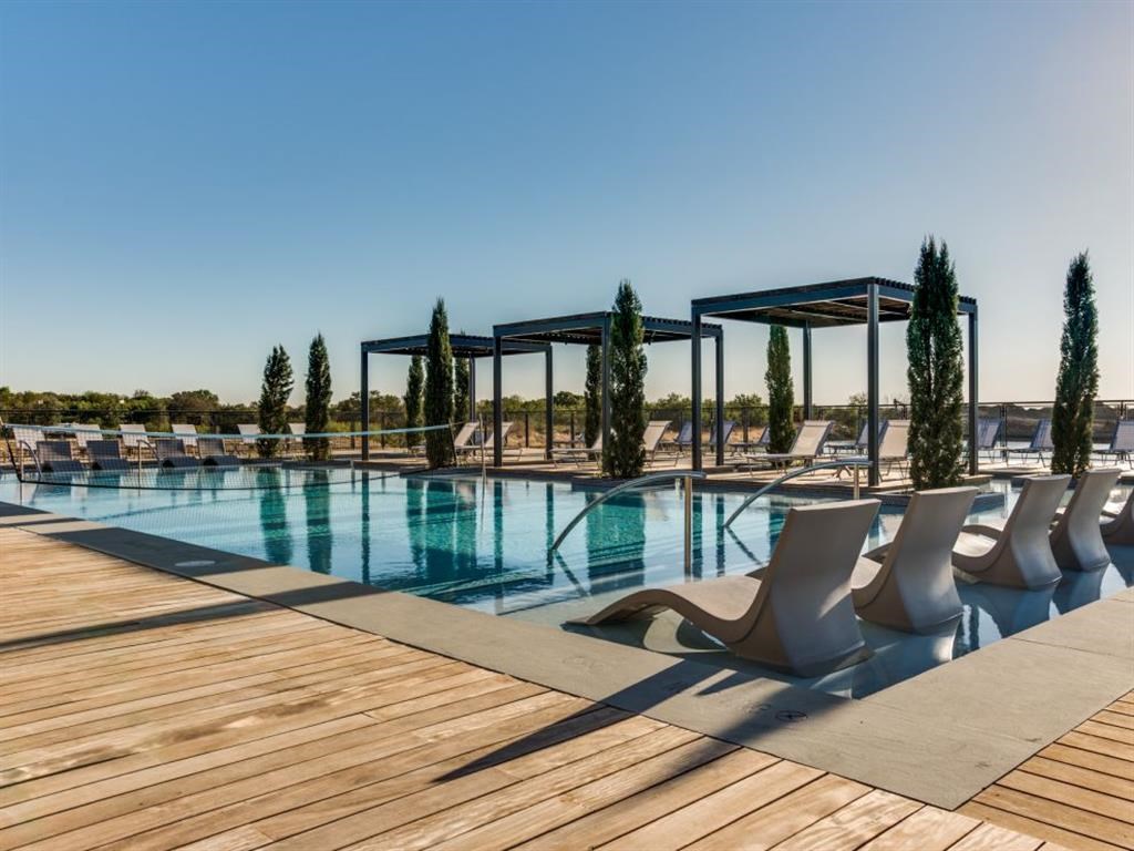 a swimming pool with chairs on a wooden deck
